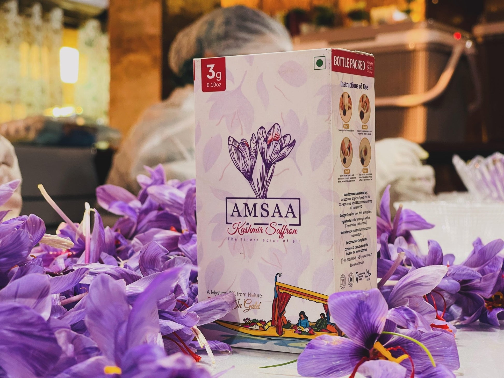 Premium Kashmiri saffron gift pack by Amsaa amidst fresh saffron flowers, perfect for saffron enthusiasts and culinary connoisseurs